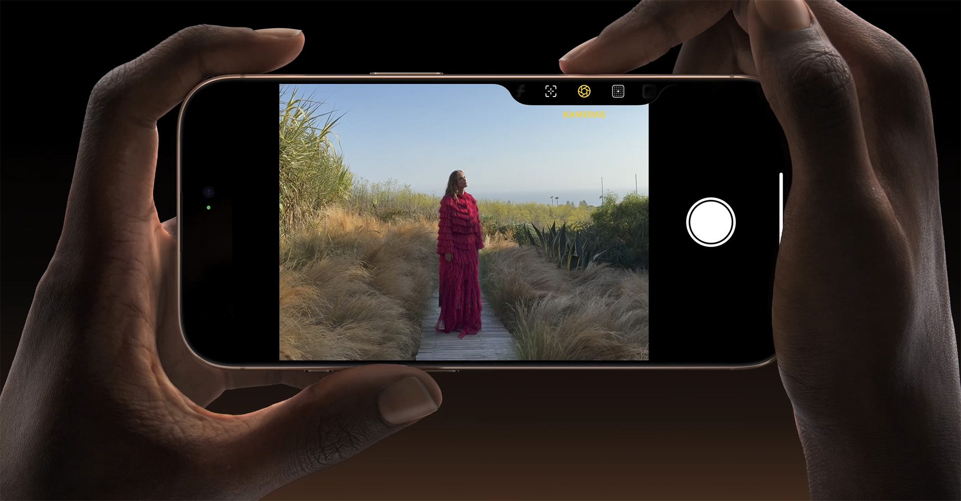 Zwei Hände halten ein iPhone 16 Pro, um ein Foto zu machen